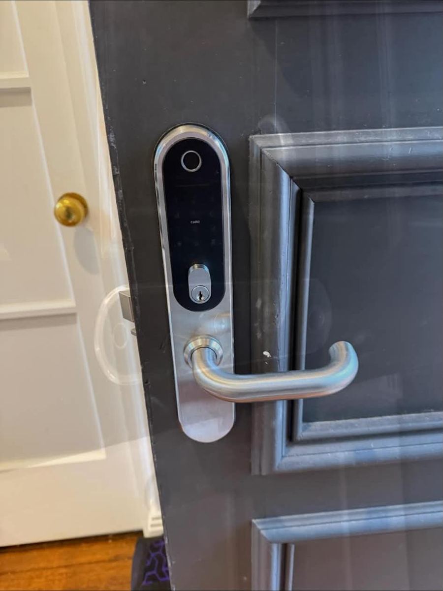 Fingerprint smart lock installed on a panelled front door